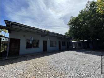 Exterior with multiple apartment units and gravel parking area in David Panama