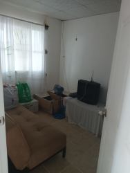 Minimalist dining area with windows tile floor and simple table in Los Guayacanes house La Chorrera Panama