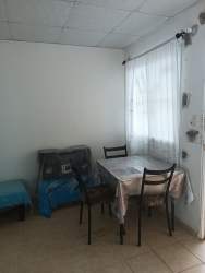 Small bedroom with bed sheer curtains white walls starter home in La Chorrera Panama