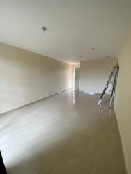 Minimalist bedroom with tile floors, large window greenery views at Residencial La Primavera