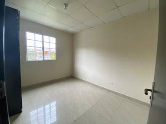 Compact modern kitchen with dark cabinets, stainless sink, tiled backsplash in La Primavera