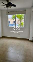 Open kitchen with wood cabinets and ceramic countertops in PH Coronado Paradise Panama