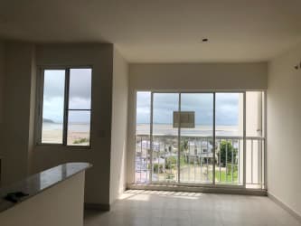 Living room with sliding doors to ocean view balcony in Playa Dorada Vacamonte Panama