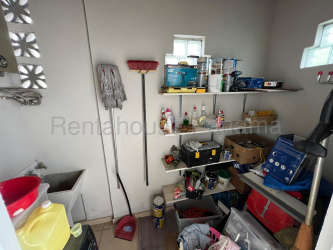 Living room with sofas, TV, pendant lighting, open plan layout in family house Panama