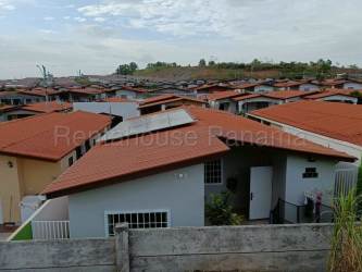 Main gated entrance of Brisas del Golf Arraijan with security control and palm landscaping