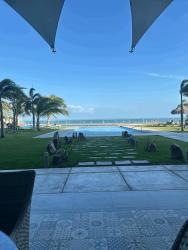 Bright living space with double-height ceiling, floor-to-ceiling windows, ocean view balcony in PH Nueva Gorgona