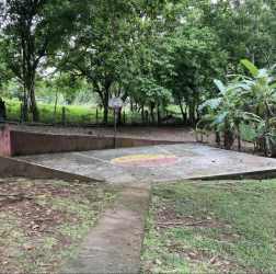 Concrete basketball and recreation court with surrounding trees on country estate Capira Panama