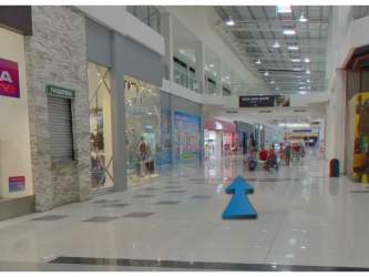 Mall interior corridor with multiple retail units and storefronts in Santiago Mall Panama