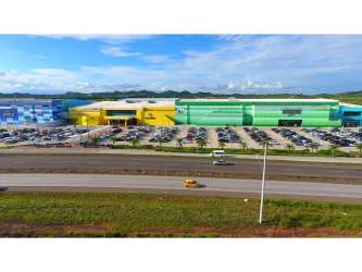 Aerial perspective of large Santiago Mall with parking and colorful facade in Santiago Panama