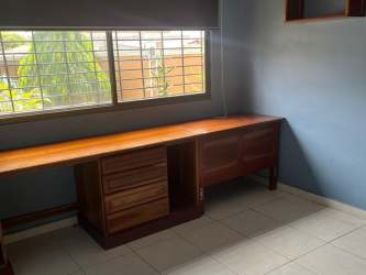 Minimalist home office with built-in desk and window Paseo Miramar La Chorrera