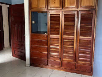 Bedroom featuring built-in wooden wardrobe in house rental Paseo Miramar La Chorrera