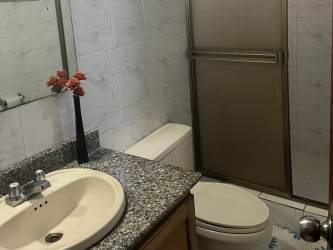 Traditional bathroom with granite countertop sink and glass shower in house for rent La Chorrera