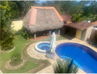 Bright open-concept living and dining space with large windows and tile floors in Coronado Panama beach house