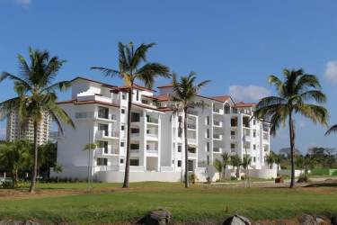 Mediterranean inspired multi-story residential condos with balconies overlooking gardens and pool at Islamar Vistamar Panama