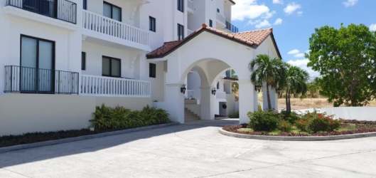 Mediterranean inspired architecture building with arches balconies and gardens at Islamar in Vistamar Beach Golf Marina Panama