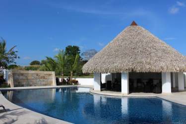 Lagoon swimming pool with waterfall and shaded palapa lounge at Islamar Vistamar Golf Beach Marina