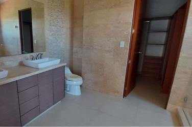 Exterior of Mediterranean-style villa and condo complex with balconies, red tile roof and tropical landscaping at Islamar Vistamar Panama