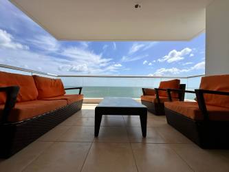 Modern balcony with orange outdoor furniture and panoramic Pacific Ocean views in Playa Gorgona Panama