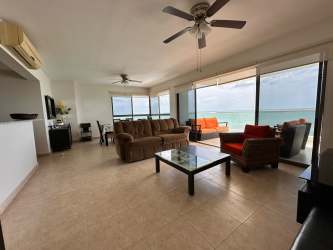 Living room with large windows, ceiling fans, coastal décor and Pacific Ocean view Playa Gorgona Panama