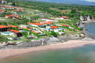 Aerial of beachfront villas red tile roofs pools tropical Vista Mar Panama
