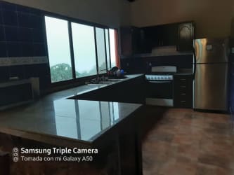 Spacious kitchen with granite countertops, natural light, and custom cabinetry in Altos del María Panama
