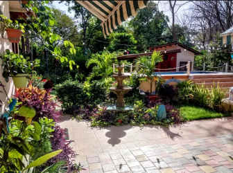 Covered terrace with hammock and lush landscaping on Panama countryside home in Los Lirios El Valle