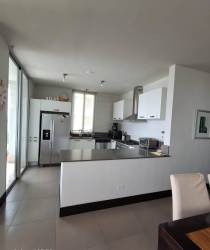 Fully equipped modern kitchen with granite countertops and stainless steel appliances in PH Rio Mar, Nueva Gorgona Panama