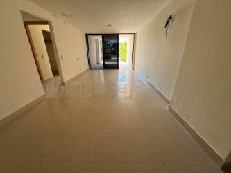 Bright living and dining room opening onto oceanview balcony in Casamar Resort condo Panama