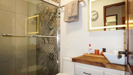 Covered patio with ceiling fans, outdoor seating, garden view in Nueva Gorgona beach house