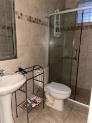 Modern bathroom with glass shower enclosure and pedestal sink Brisas del Golf Arraiján Panama