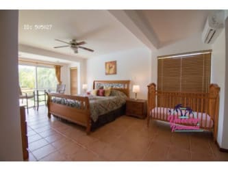 Large open-plan living and dining room with lake view inside vacation villa at Royal Decameron Costa Blanca Panama