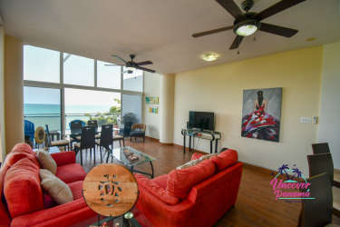 Modern kitchen with granite counters, stainless refrigerator, high stools and tile floor Miramar Loft Coclé Panama