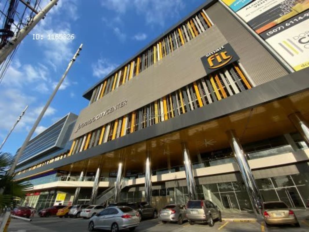 Glass storefront commercial units with signage visible in Dorado City Center Panama City