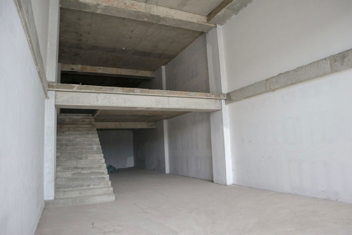 Shell condition interior commercial space with concrete mezzanine and stairway in Dorado City Center Panama