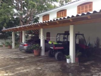 Rustic Mediterranean kitchen with wooden cabinets and vibrant blue tiles in Playa Blanca Panama