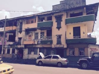 Colonial architecture three-story building retail spaces and balconies Ciudad de Colón Panama