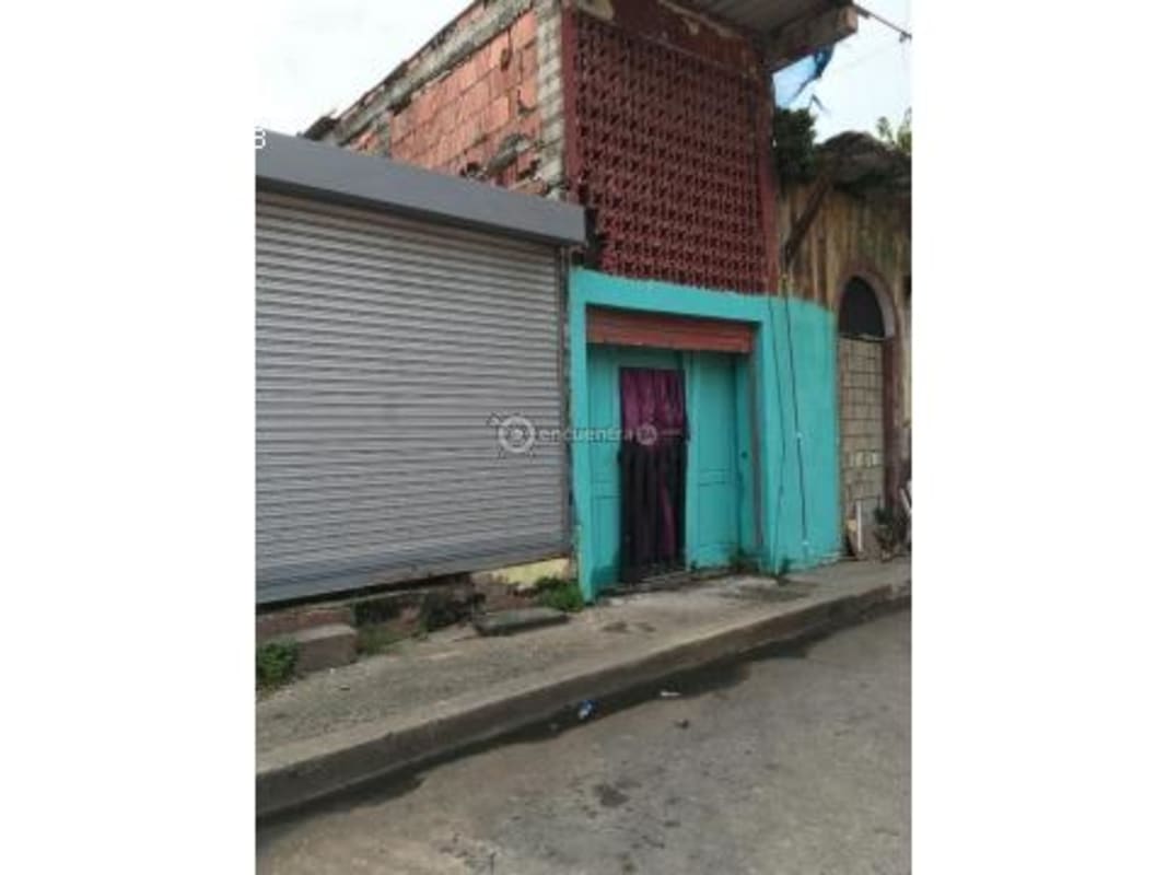 Rustic entrance with brown wooden door and graffiti wall in Casco Viejo Panama City